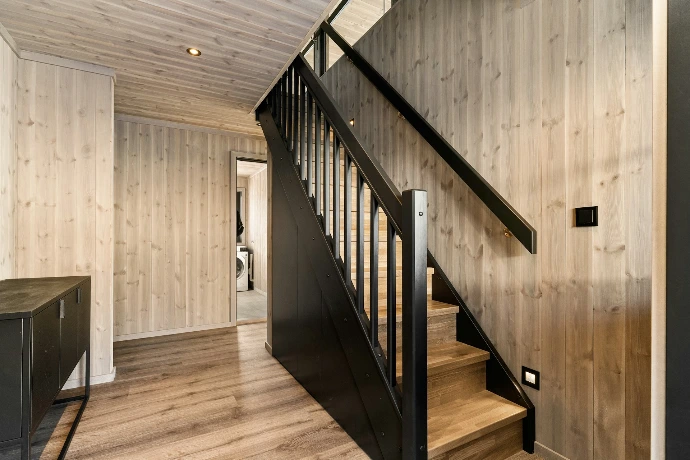A room with a wooden floor and a stair case